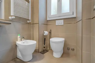 a bathroom with a toilet and a sink at CASA REMO - for family, 2 bathrooms, AC, self check-in in Rome