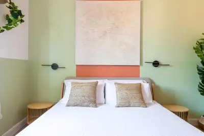 a bedroom with a white bed with two pillows at Milo Apt - Trastevere's Gem in Rome