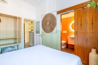 a bedroom with a white bed and a bathroom at Milo Apt - Trastevere's Gem in Rome