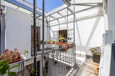a greenhouse on a balcony with potted plants at Milo Apt - Trastevere's Gem in Rome