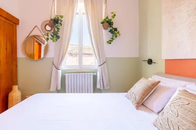 a bedroom with a white bed and a window at Milo Apt - Trastevere's Gem in Rome