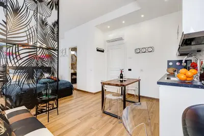a kitchen and a living room with a table at Roma in Relax Lovely Loft in the center of Rome Fabrizia in Rome