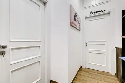 a hallway with white doors and wood floors at Roma in Relax Lovely Loft in the center of Rome Fabrizia in Rome