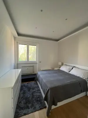 a bedroom with a large bed and a window at Moderno bilocale con terrazzo in Rome