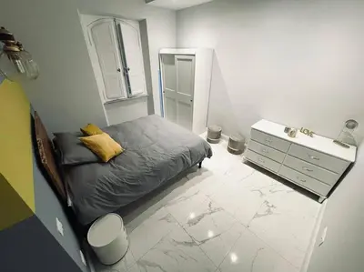 a small bedroom with a bed and a dresser at Vatican Tiny House in Rome