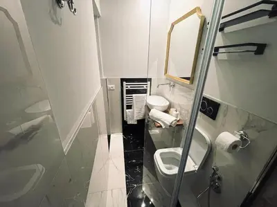 a bathroom with a toilet and a sink and a mirror at Vatican Tiny House in Rome