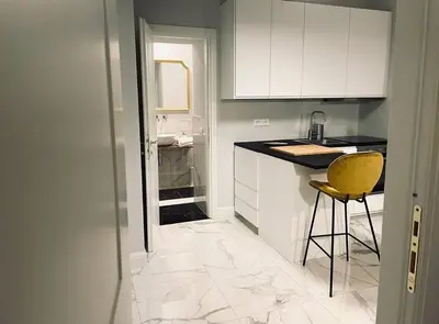a kitchen with a counter and a yellow chair in it at Vatican Tiny House in Rome