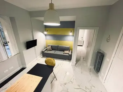 a living room with a couch and a table at Vatican Tiny House in Rome