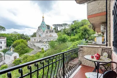 a balcony with a table and a view of a building at Loft Shabby Chic con vista vicino al Vaticano in Rome