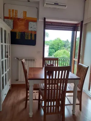 a dining room with a table and chairs and a window at Loft Shabby Chic con vista vicino al Vaticano in Rome