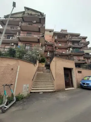 a building with stairs in front of a parking lot at Loft Shabby Chic con vista vicino al Vaticano in Rome