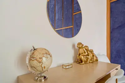 a table with a globe and a statue on it at Casa Blu Testaccio in Rome