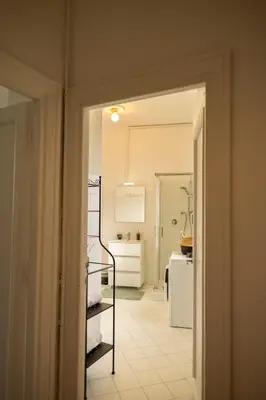 a room with a hallway with a kitchen and a staircase at Porto Fluviale Penthouse - Rome Collection in Rome