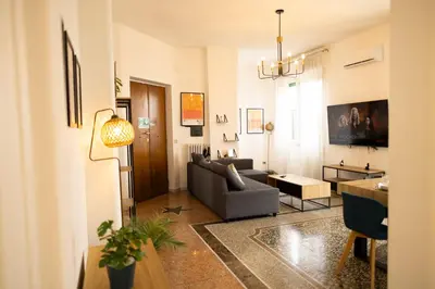 a living room with a couch and a table at Porto Fluviale Penthouse - Rome Collection in Rome