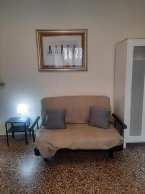 a couch in a living room with a picture on the wall at Nido Vidaschi in Rome
