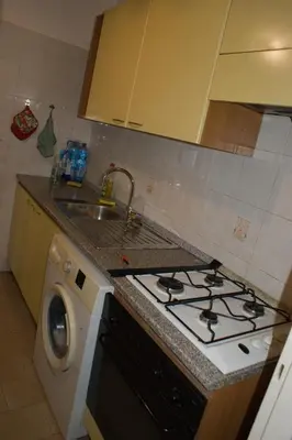 a kitchen with a stove and a washing machine at Nido Vidaschi in Rome