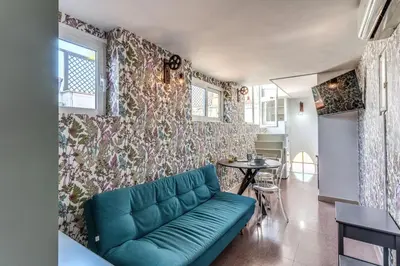 a living room with a couch and a table at Terrazza Ippocrate in Rome