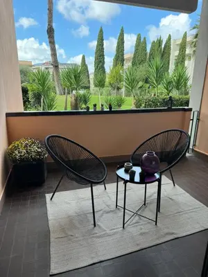 a balcony with chairs and a view of trees at Aurelia Green Suite in Rome