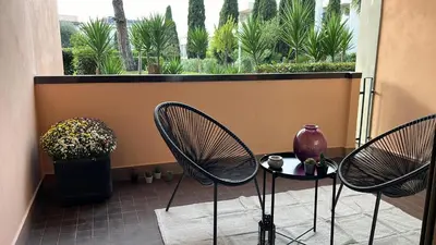 two chairs and a table in front of a window at Aurelia Green Suite in Rome