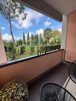 a table under an umbrella next to a swimming pool at Aurelia Green Suite in Rome