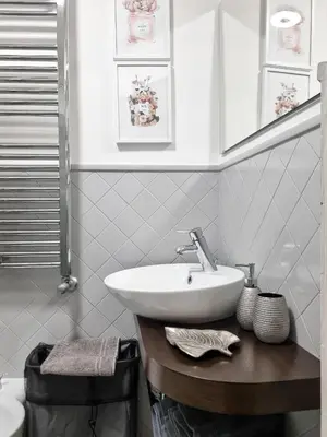 a bathroom with a sink and a toilet at Colosseum Historic Apartment - 17th Century Building in Rome