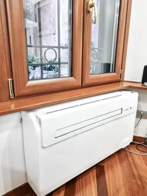 a white drawer under a window at Colosseum Historic Apartment - 17th Century Building in Rome