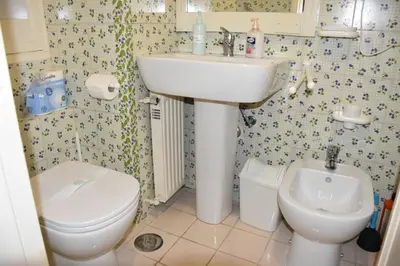 a bathroom with a white sink and a toilet at Carla Luxury House in Rome
