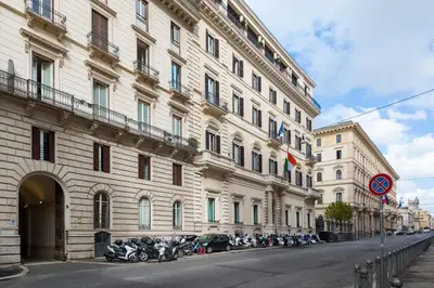 a large building with motorcycles parked in front of it at Carla Luxury House in Rome