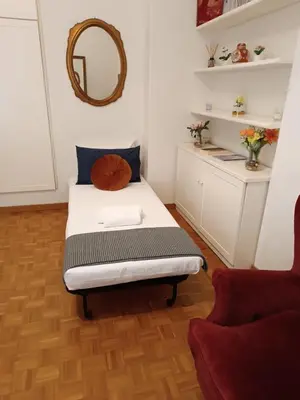 a small bedroom with a bed and a mirror at Carla Luxury House in Rome