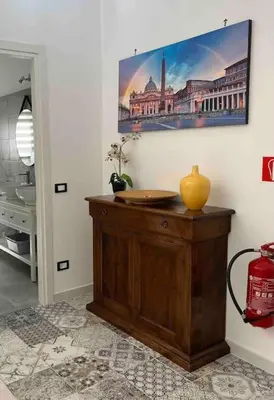 a room with a table with a vase on it at 3 FERMATE DAL COLOSSEO - Casa Vacanze Elena - 50 m da METRO GARBATELLA in Rome