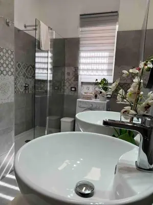 a bathroom with two sinks and two toilets at 3 FERMATE DAL COLOSSEO - Casa Vacanze Elena - 50 m da METRO GARBATELLA in Rome