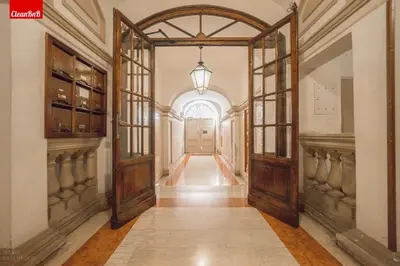 an ornate hallway with an open door at GuestHost - La finestra sui palazzi di Roma Apartment in Rome