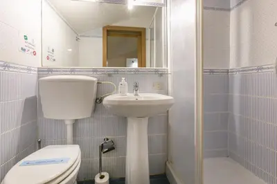 a small bathroom with a toilet and a sink at Trevi Little Palace #9 in Rome
