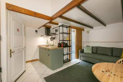 a kitchen and living room with a couch and a table at Trevi Little Palace #9 in Rome