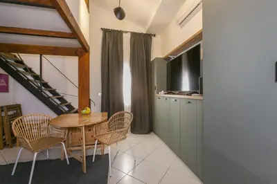 a kitchen and dining room with a table and chairs at Trevi Little Palace #9 in Rome