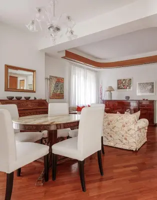 a living room with a table and chairs and a couch at Vatican Museum Apartment - ZENO 26 in Rome