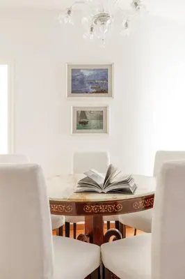 a room with a table with an open book on it at Vatican Museum Apartment - ZENO 26 in Rome