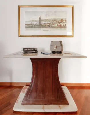 a wooden table with a glass top on top at Vatican Museum Apartment - ZENO 26 in Rome