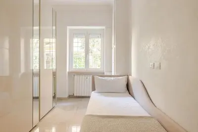 a white room with a bed and a window at Casa Caterina - Modern design apartment near Vatican City in Rome
