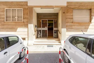 two white cars parked in front of a building at Casa Caterina - Modern design apartment near Vatican City in Rome