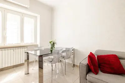 a living room with a table and a couch at Casa Caterina - Modern design apartment near Vatican City in Rome