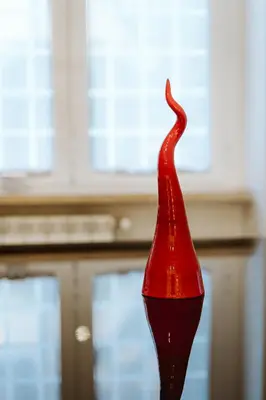 a red glass sculpture in front of a window at Casa Caterina - Modern design apartment near Vatican City in Rome
