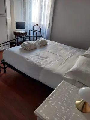 a bedroom with a large bed with towels on it at Tra le antiche mura e Garbatella in Rome