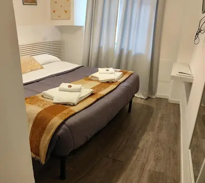 a bedroom with a bed with towels on it at Vaticano San Pietro metro ottaviano in Rome