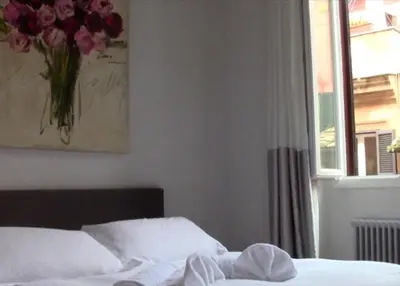 a bedroom with a bed with a vase of flowers at Antiche Residenze Romane Navona in Rome
