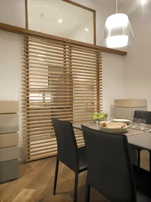 a dining room with a table and chairs and a kitchen at Antiche Residenze Romane Navona in Rome