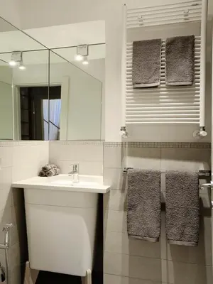a bathroom with a sink and a mirror and towels at Antiche Residenze Romane Navona in Rome