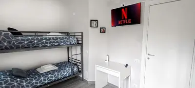 a bedroom with a bunk bed and a desk at Rome Essence Apartament in Rome