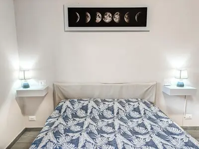 a bedroom with a bed and two night stands at Rome Essence Apartament in Rome