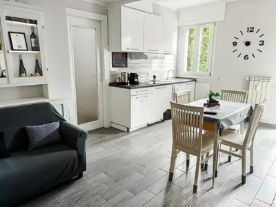 a kitchen and dining room with a table and a couch at Rome Essence Apartament in Rome
